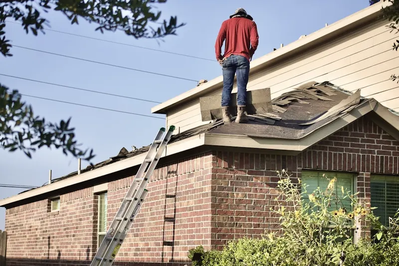 Professional roofer working on a residential roof in Bernharts